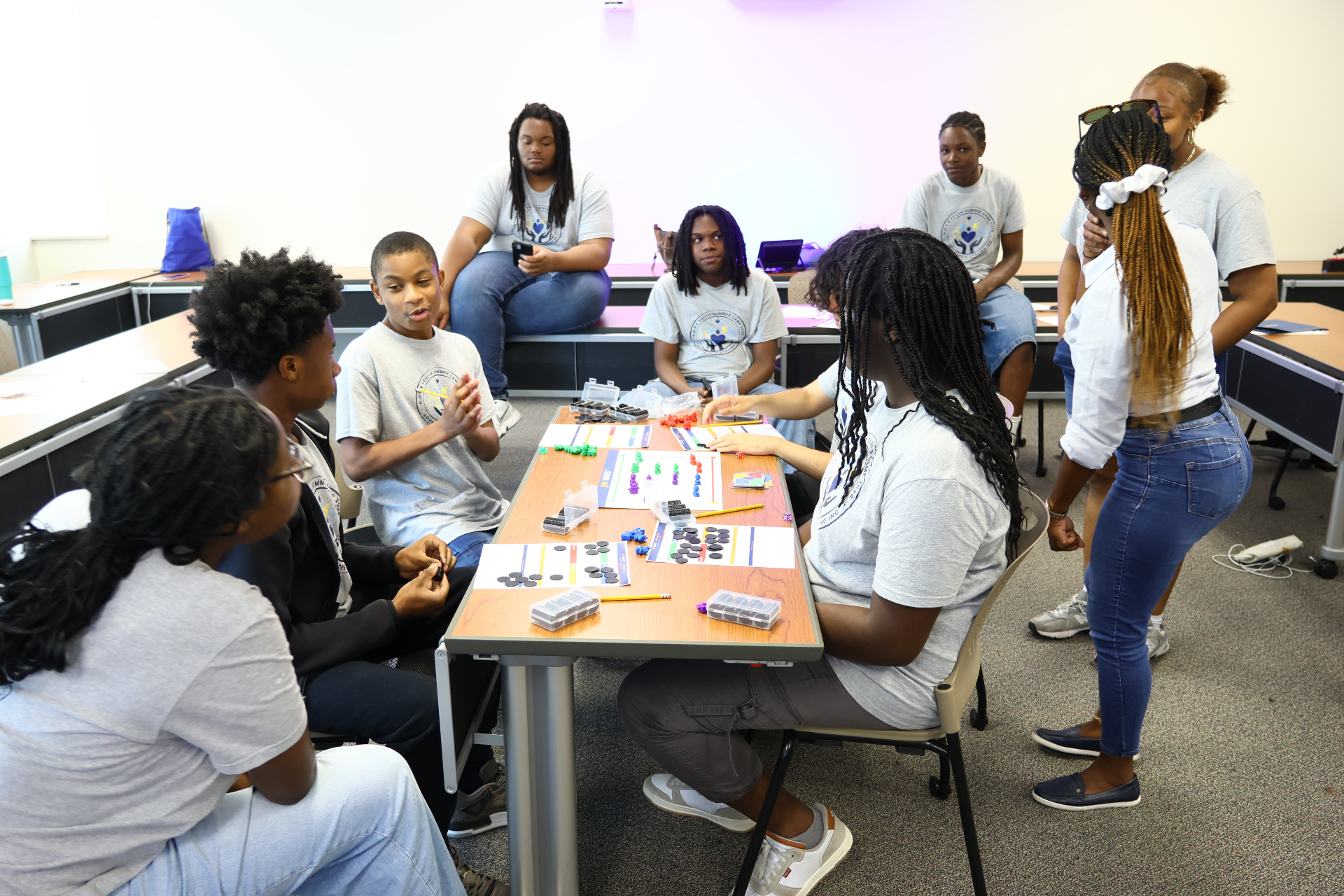 Youth participants engaged in Jar Wars™ tournament gameplay around a shared table