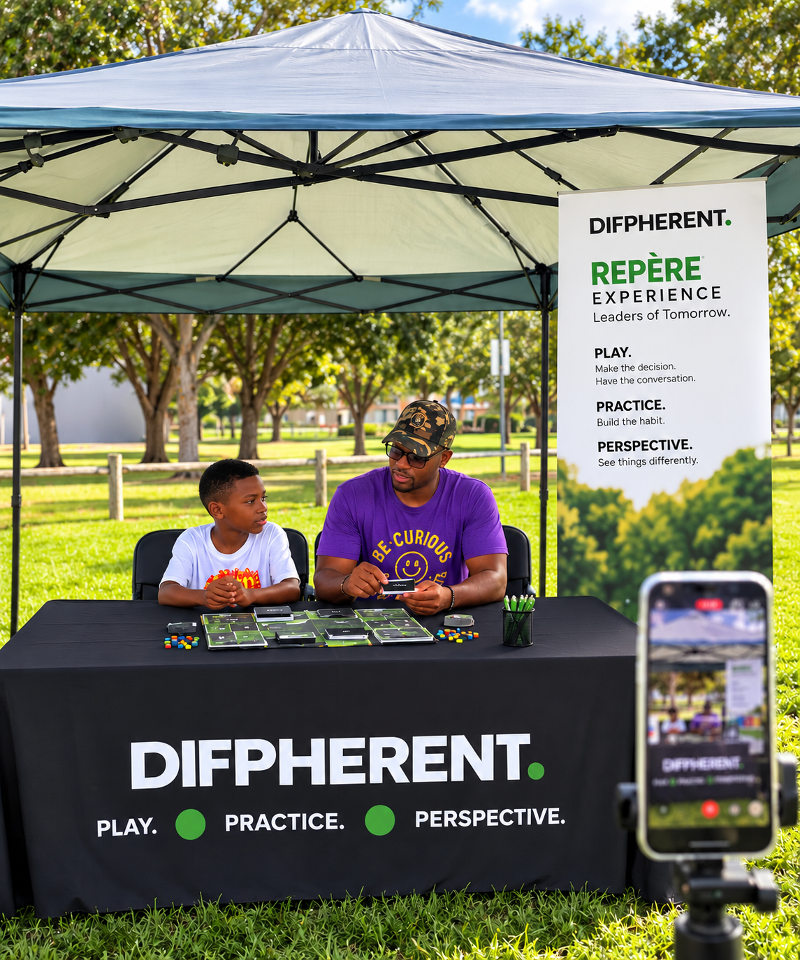 Promotional concept for the REPÈRE Experience: an adult and a young person seated at a DIFPHERENT park booth with a decision-making board and tokens